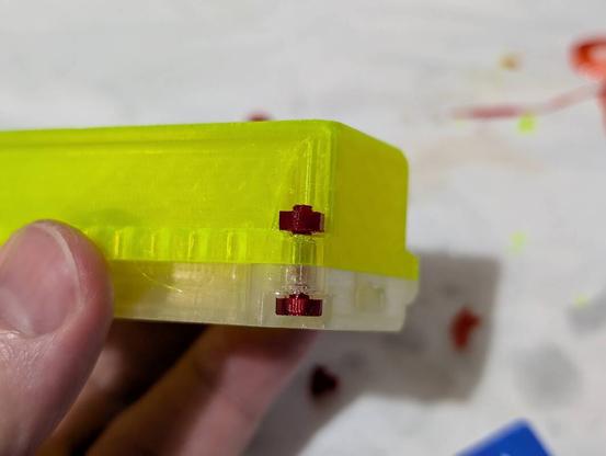 A screw and a nut printed in cheap transparent PETG.