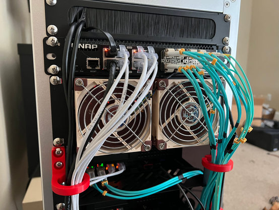 The Noctual NF-A9 2U ventilation plate installed below the QNAP switch to draw the RPi heat out of the rack instead of letting the Minisform MS-A2 try to use the warm air for cooling.