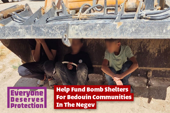 An image of kids hiding beneath some kind of bench in the desert sun. The caption says "Everyone Deserves Protection. Help fund bomb shelters for Bedouin communities in the Negev"