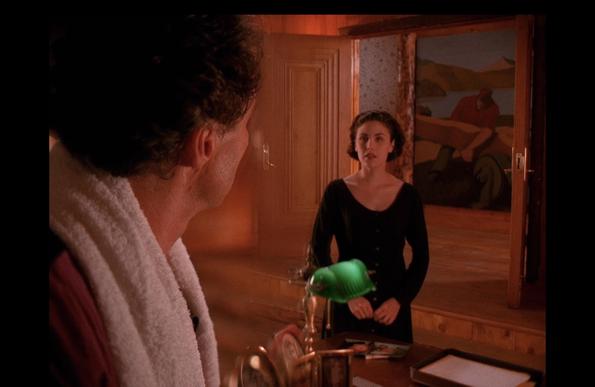 A still from Twin Peaks. To the left of the image is Ben Horne, close to the camera, facing Audrey Horne, further away to the right of the image. A split diopter keeps both in focus.