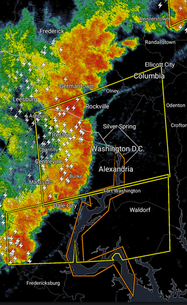 A reflectivity radar map of the Washington DC, Maryland, and Virginia area. A large band of heavy storms approaches Washington DC, with a lot of lightning strike indicators. Two boxes covering much of the area show severe thunderstorm warning regions.