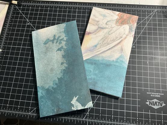 Closed notebooks, with cover of watercolor paintings