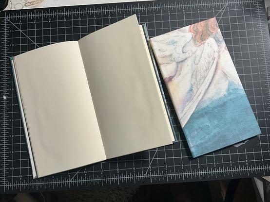 Two notebooks, one is open and the other is closed