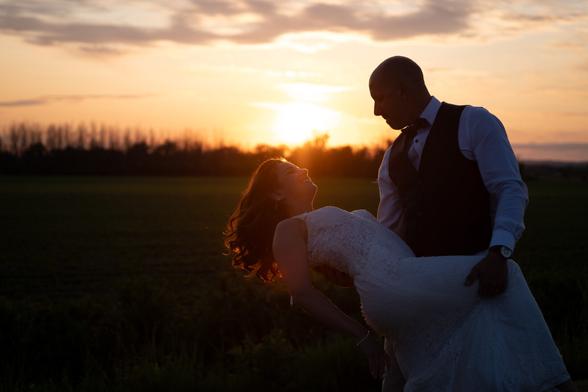 Picture of a newlywed couple on sunset.