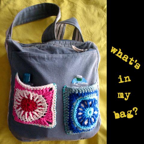 Photo of a blue canvas-cotton messenger bag laying on yellow fabric. On the front of the bag are two granny square pockets, one pink-red-white, and one with blue and white colours. Next to the photo is the text: "What's in my bag?"