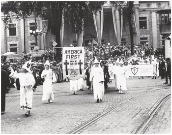 Klu-Klux-Clan march, white pointed hats, "America First"