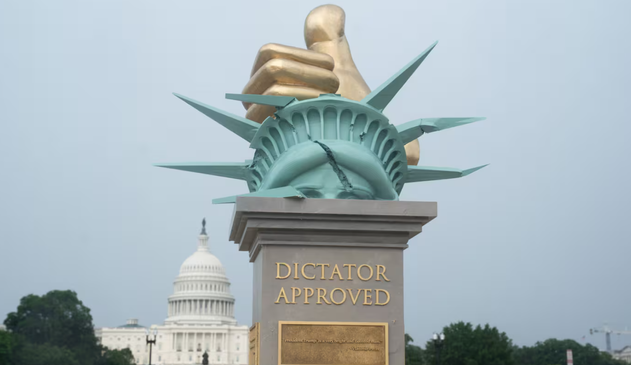 The sculpture features a gold hand crushing the Statue of Liberty's crown, criticising authoritarianism. Photo / Maxine Wallace via the Washington Post
