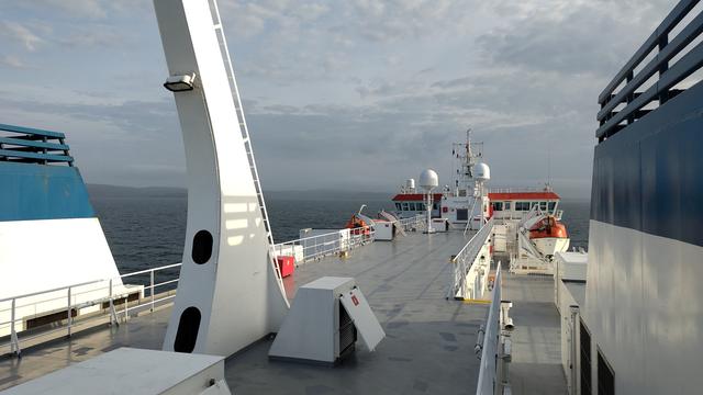 Image of the upper deck of the ferry, Shetland in the background.