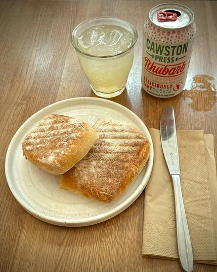 Ham, cheddar and caramelised red onion marmalade toastie, cut in half, at Milk Bar