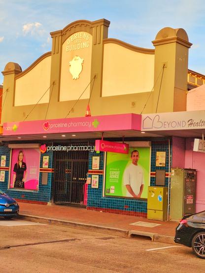 An art deco shop front titled "O'Brien's Building 1930", which is now home to a very pink Priceline store.