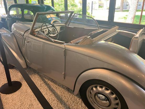 Silver Skoda 927 Popular convertible showing rear ‘dickey seat’, rear quarter view