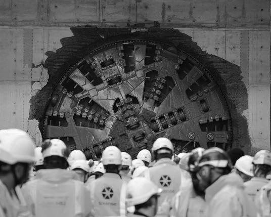 HS2 workers watch a boring machine breaking through at Washwood Heath depot near Birmingham, 9 May 2025. 

Photograph: Jacob King/PA – from The Guardian, 20 June 2025