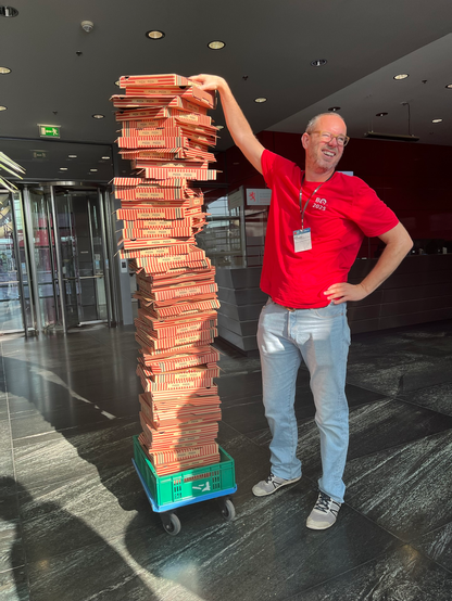 @claushoumann@mastodon.social next to a huge pile of empty pizza boxes