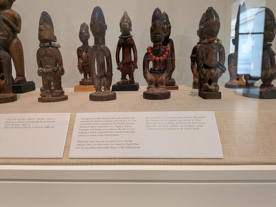 A case of carved figures from various countries in Africa which were placed on Trump's travel bans during his first admin
 The point is highlighting the hypocrisy of allowing artifacts to move while restricting the artifact creators.