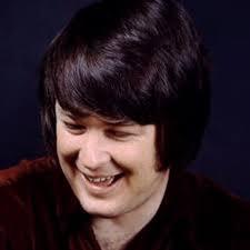 Young Brian Wilson of The Beach Boys gazes downward while smiling.