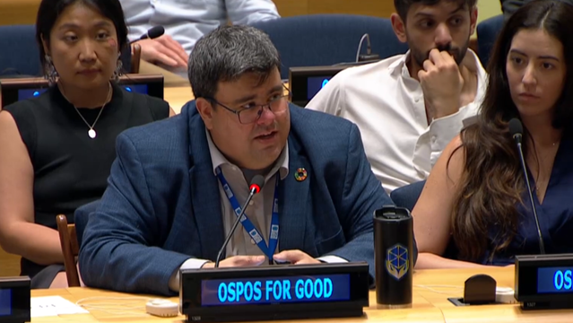 Michael Downey speaking at a UN microphone.