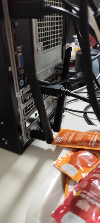 The new WiFi card with its antenna poking out.