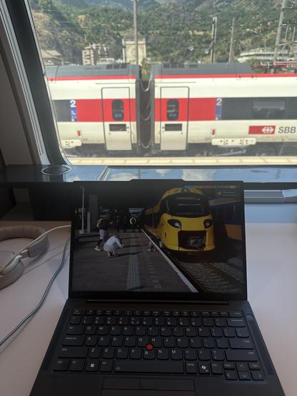 Laptop behind it the window