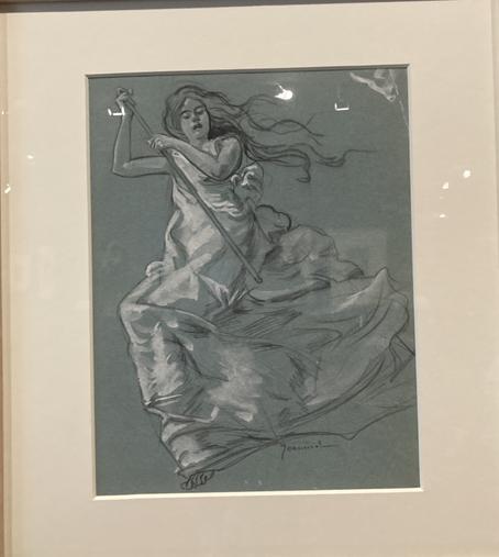 Dessin à la pierre noire et à la gouache sur un papier bleu, encadré d'une marie-louise blanche.
Une femme est représentée vue en contre-plongée, comme si elle flottait dans l'air. Sa robe ample est soulevée par l'air ou le vent et fait un grand pan de tissu dans la moitié inférieure du dessin. Le buste de la femme est représenté à gauche ; elle tient dans ses deux mains un grand bâton. Ses cheveux flottent au vent.
Il s'agit d'un dessin de Pierre Georges Jeanniot, intitulé La sorcière, daté vers 1900, en collection particulière