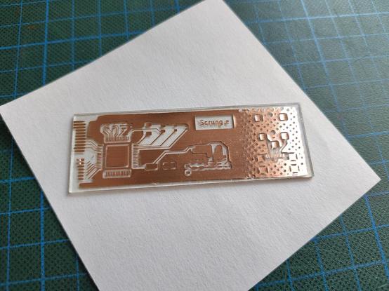 Same PCB after etching. A lot of the copper around the edges has been eaten away where it shouldn't have and a lot of the small features have delaminated