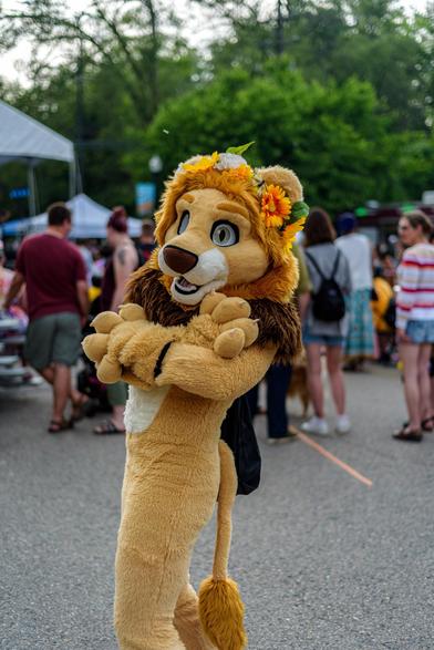 A lion fursuiter wit ha flower crown