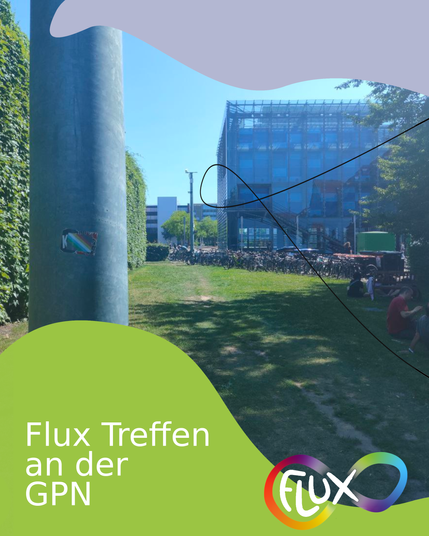 A photo of the location of the Flux HSG Meetup at GPN23, behind the kitchen near the ZKM entrance on the grass below a disability pride flag sticker on a pole.