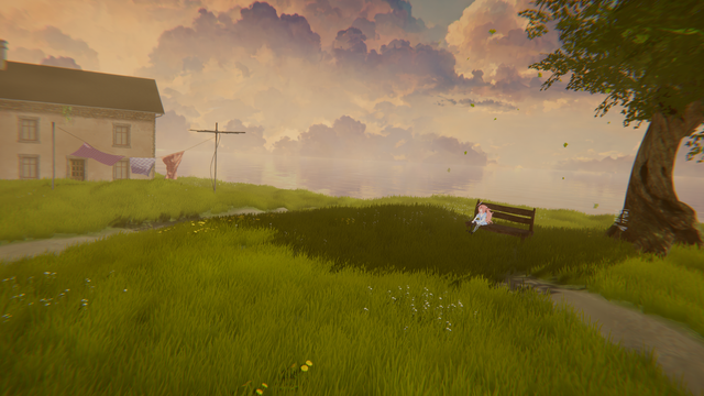 View of a grassy field in front of a house. An avatar is sitting on a bench under the shade of a tree.