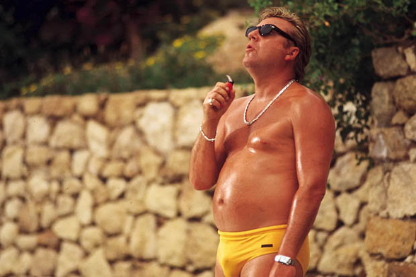 Actor Ray Winstone in tell budgie smugglers sweating in the sun on the set of the movie Sexy Beast