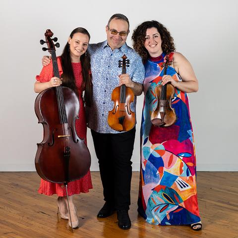 a posed photo of Trio Fadolín holding their instruments, photo by Grant Henry