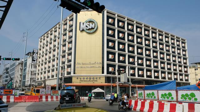 Daylight color photo of the Min Sen Building constructed in the 1960's at a busy traffic intersection near Bangkok Chinatown.