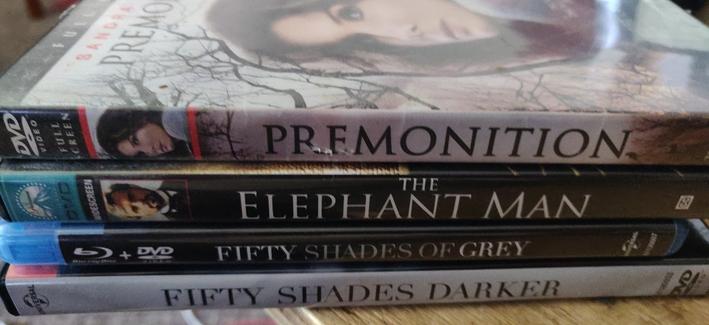 Three DVDs and a Blu Ray in a neat little stack.