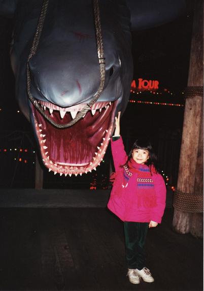 Photo of Chicago artist Jenny Lam when she was 8 years old posing with Jaws at Universal Studios Hollywood in December 1995