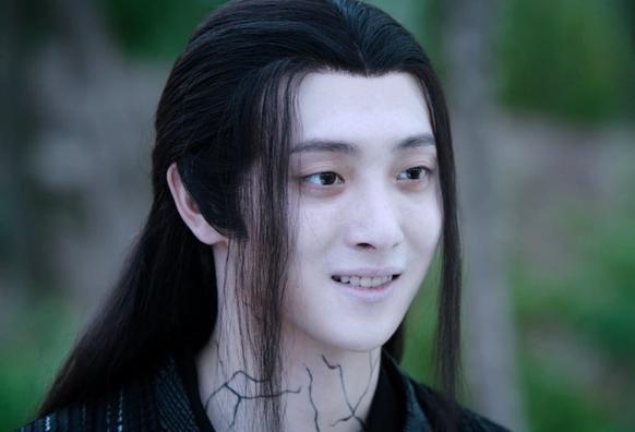 Wen Ning, hair simply tied back and spidery black veins creeping up his neck, smiles happily at someone or something out of frame beyond the right side of the image.