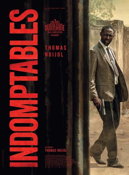 The image is a movie poster for the film "Indomptables," directed by Thomas Ngiol. The poster features a man in a brown suit, white shirt, and patterned tie, holding a gun in his right hand. He is walking on a dirt path with a weathered wall in the background, suggesting an urban or rural setting. The title "INDOMPTABLES" is prominently displayed in large red letters on the left side of the poster. The text "Quinzaine des Réalisateurs Cannes" is visible, indicating the film's selection at the Cannes Film Festival. The name "Thomas Ngiol" is also featured, likely indicating the director. The overall color scheme is dark with red accents, creating a dramatic and intense atmosphere.