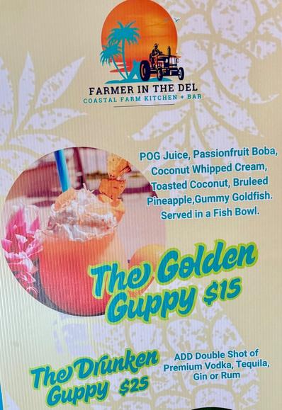 The Golden Guppy is a Hawaiian style drink POG juice, Passionfruit boba, coconut whipped cream, toasted coconut, brûlée pineapple, gummy goldfish, served in a fishbowl. Can add rum for extra cost.