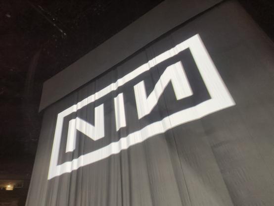 Logo of the band of nine inch nails on a curtain after a concert