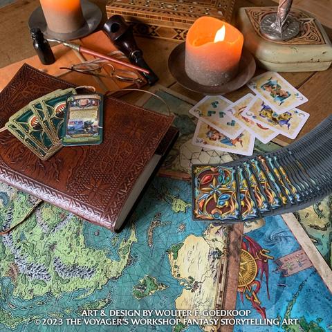 A variety of fantasy maps are on display with fantasy themed playing cards, leather bound notebooks, a bottle of ink and dip pen as well as  some candles and a pipe.