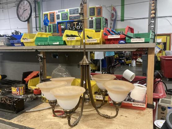 An intact ceiling light on a workbench.