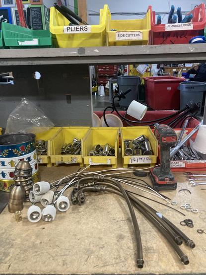 Parts of the disassembled ceiling light (e.g. sockets) sorted by type.