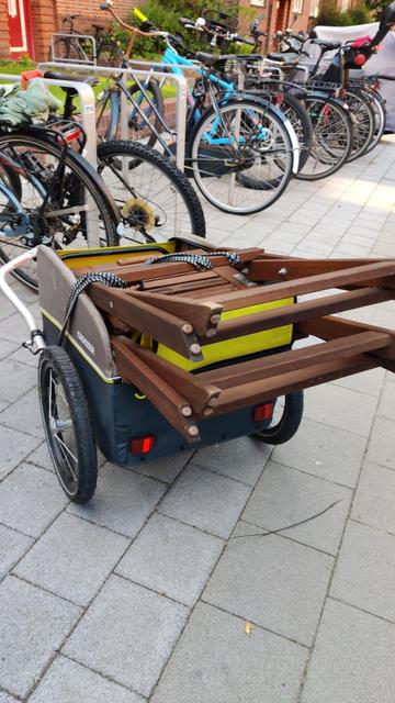 Fahrrad-Anhänger mit zwei IKEA Äpplarö Stühlen, die weit aus dem Anhänger herausragen.