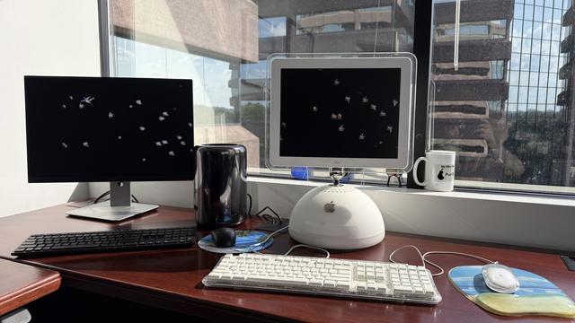 2013 Mac Pro on the left with a 2003 PowerMac G4 on the right. Both running the After Dark Flying Toasters screen saver.