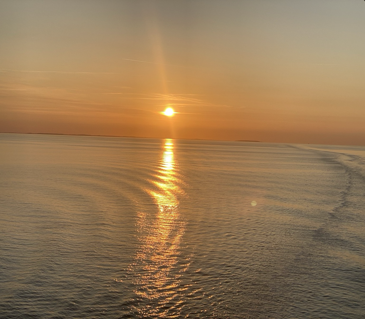 At 9:33 pm the sun is still above a tranquil Baltic Sea between the Danish islands of Funen and Zealand.