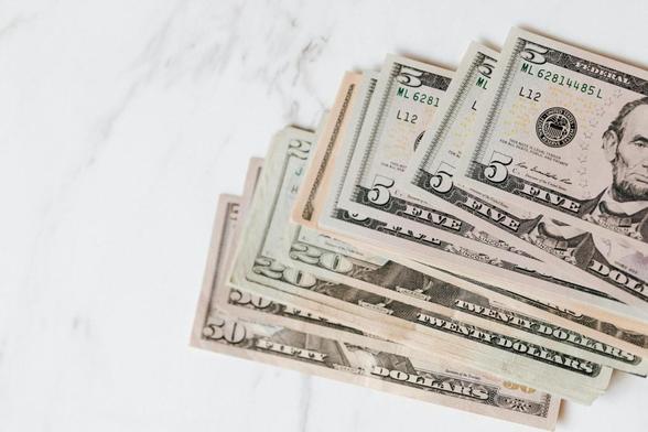 different dollar bills on marble surface