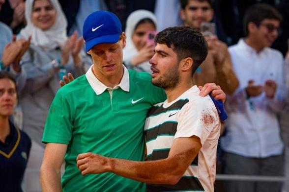 Carlos Alcaraz of Spain poses for a photo with the Coupe des Mousquetaires trophy alongside runner-up Jannik Sinner of Italy following his victory in the Men’s Singles Final match on Day Fifteen of the 2025 French Open at Roland Garros.