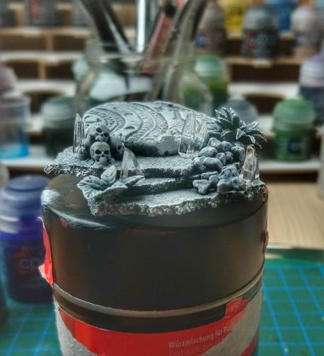 Very rough work in progress of a base for Fulgrim with some layers of stone, some plants, some skulls and a few clear crystals placed.