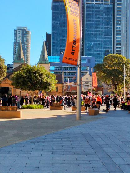 A crowd of several hundred people gathered in front of the Cathedral and Town Hall in Parramatta Square.