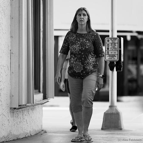 Woman walking past the camera (B&W)