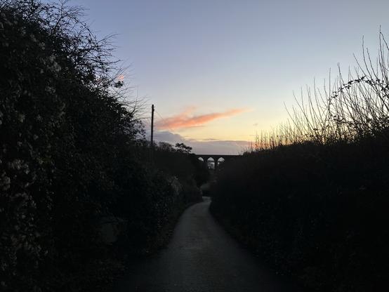 The same view, but in the depths of December. This is the winter solstice 2024. The sky is dark, the sun not yet risen from the bottom right. A smudge of orange hints at the sunrise to come