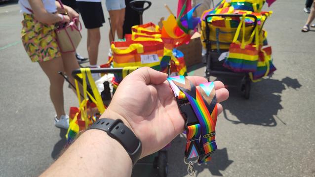 Pride lanyard and two carts full of IKEA bags and lanyards