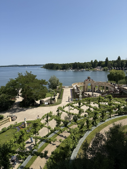 The view from a window at Castle Schwerin - formal gardens and an ornate stone plaza looking over the lake.